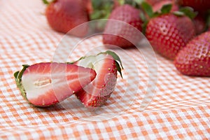 Red strawberry lying on the tablecloth